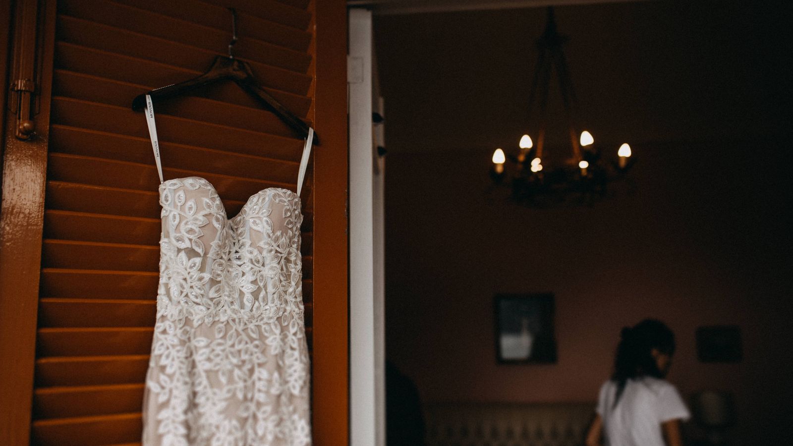 White wedding dress on a hanger inside a bright room in Beirut