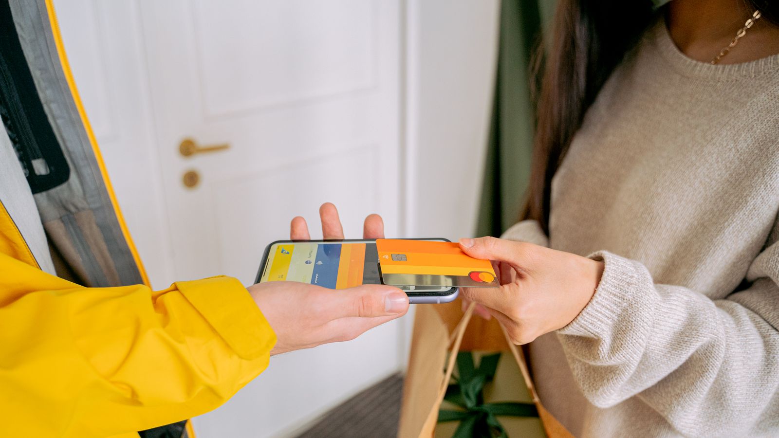 A close up of a contactless payment with a phone and credit card